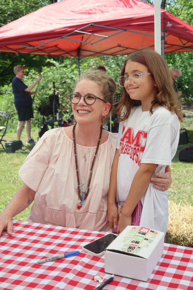 Melissa Gilbert poses with a young fan and signs copies of her book at a Shadfest event held at Barryville General on May 21. She will read from her memoir and sign books at the Deep Water Literary Festival at 5:30 p.m. on Friday, June 17 at the Gloria Krause Recital Hall, 37 Main St. in Narrowsburg.